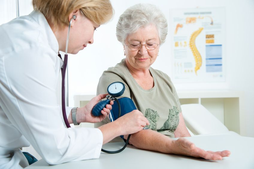 picture of woman getting blood pressure taken