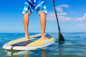 man standing on a paddleboard for exercise and fitness