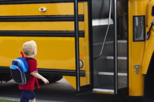 little boy safety getting on school bus