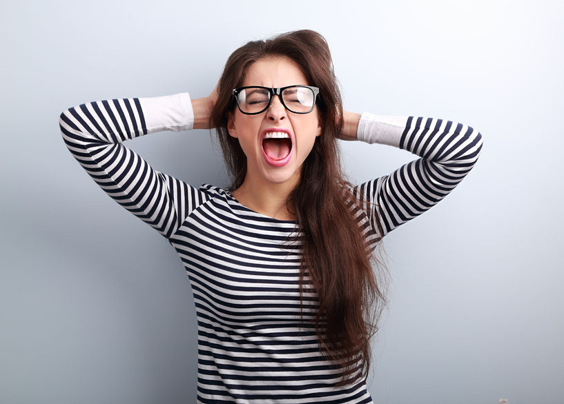 stressed out woman pulling hair and shouting