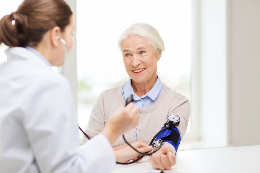 woman getting her blood pressure taken or measured