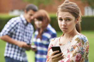 49295771 - teenage girl victim of bullying by text messaging
