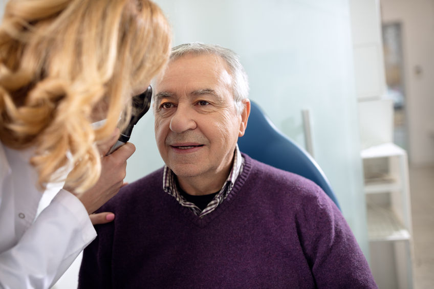 52136276 - senior looks in instrument for checking eyes at ophthalmologist