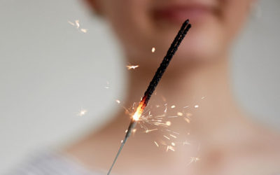 84060988 - happy young girl holding a sparkler. the atmosphere of the festival.