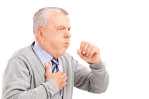 19406370 - a mature gentleman coughing because of pulmonary disease isolated on white background