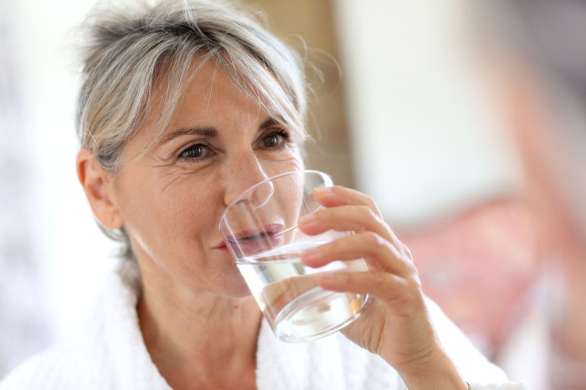 22417830 - senior woman drinking water in the morning