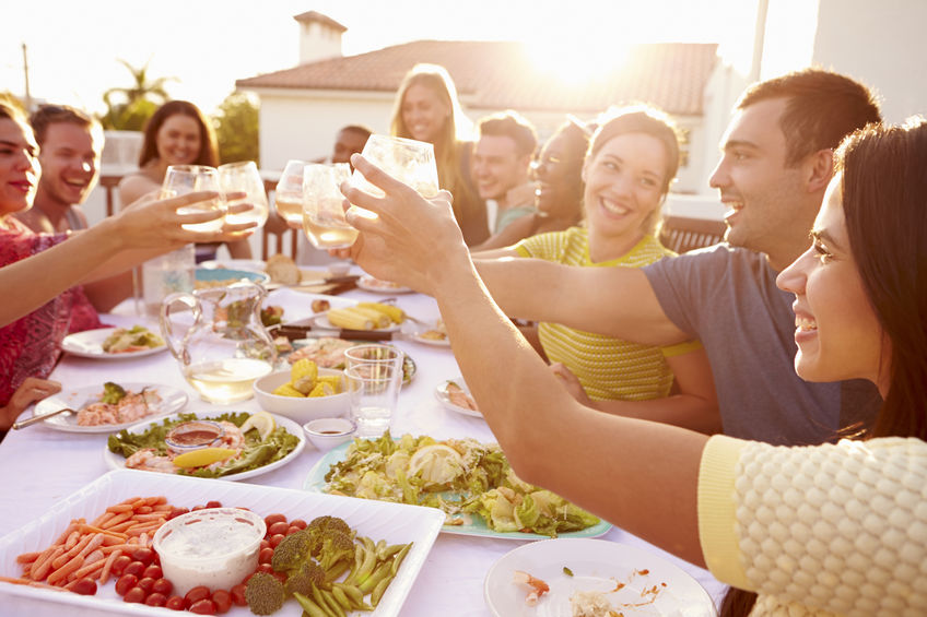 Group Of Young People Enjoying Outdoor Summer Meal