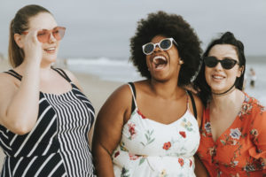 Cheerful diverse plus size women at the beach