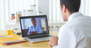 Doctor video chatting with mature patient