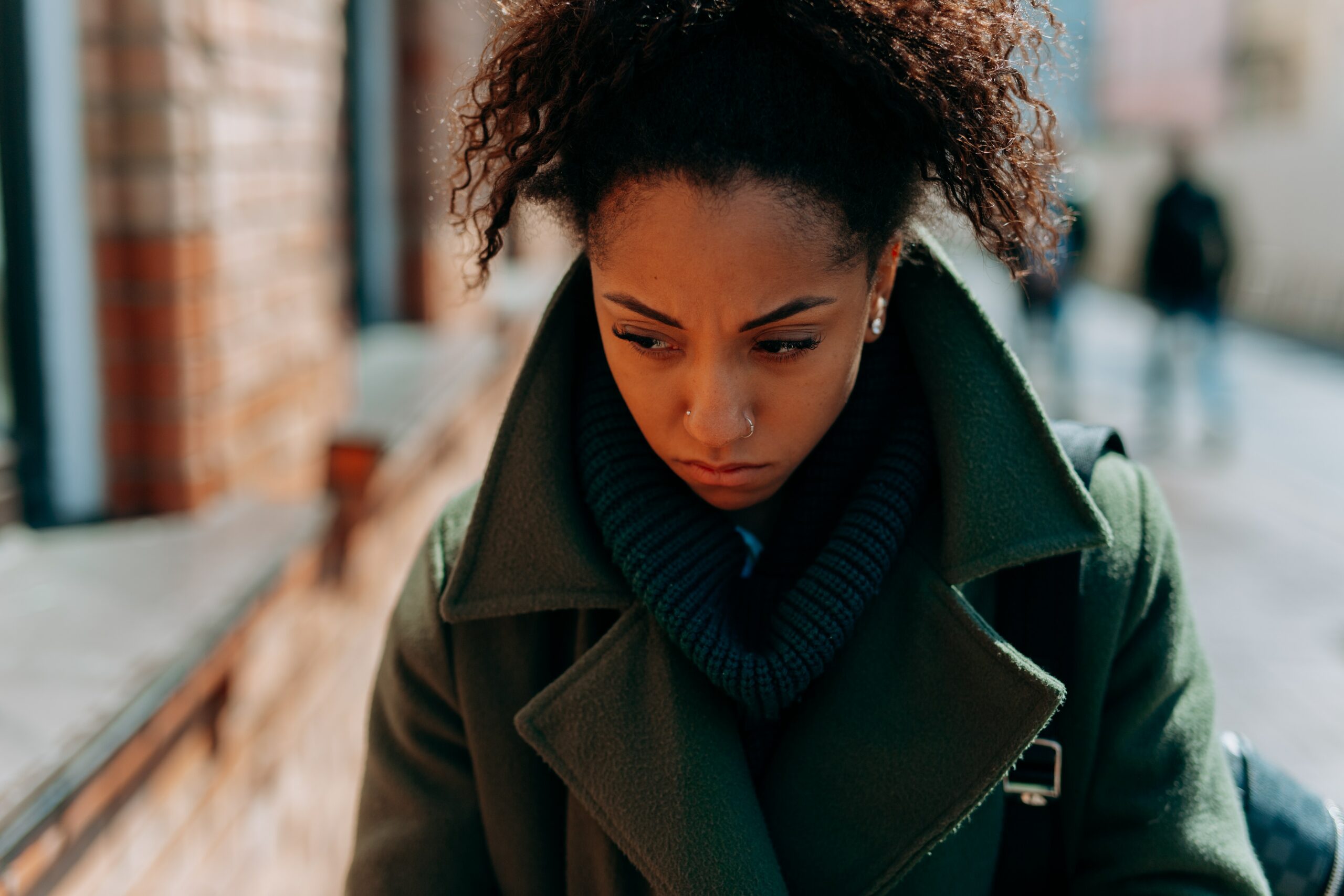 Woman walking looking sad and cold