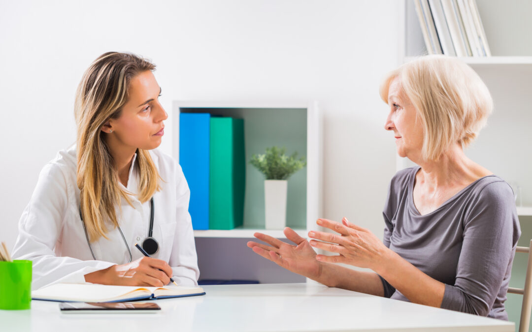 a woman sitting and talking with her doctor