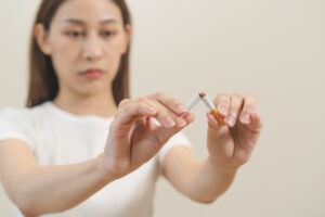 Quit, stop smoking, addiction asian young woman, girl refusing cigarette, smoker quitting smoke, hand in broken, break tobacco. Quit bad habit, health care concept. Willpower lifestyle of people.