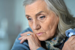 Portrait of sad senior woman at home in winter.
