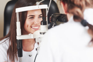 Eyes are in perfect condition. Optometrist checking vision of young beautiful woman.