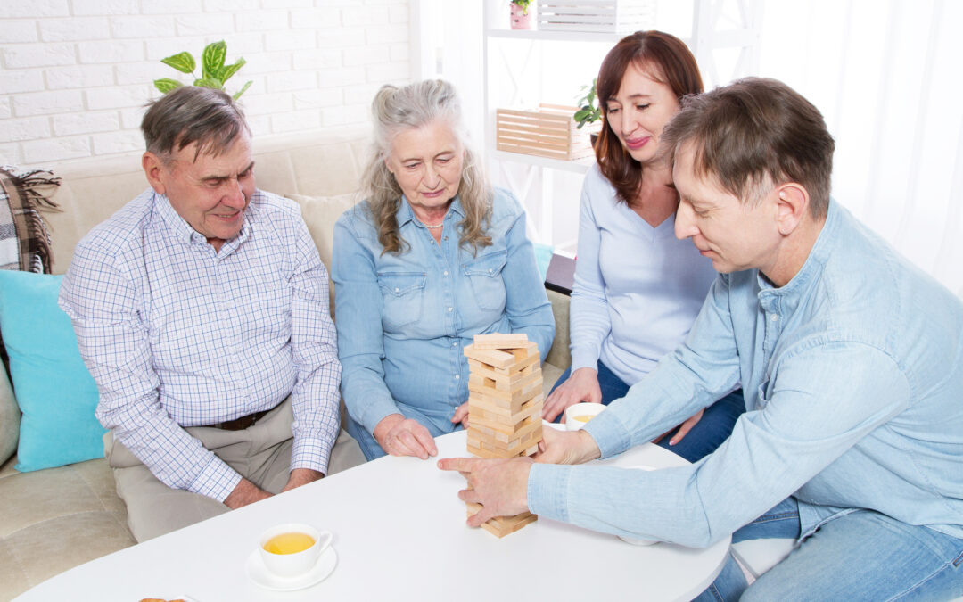 Elderly couple with family Closeup making a pyramid with empty wooden cubes close up